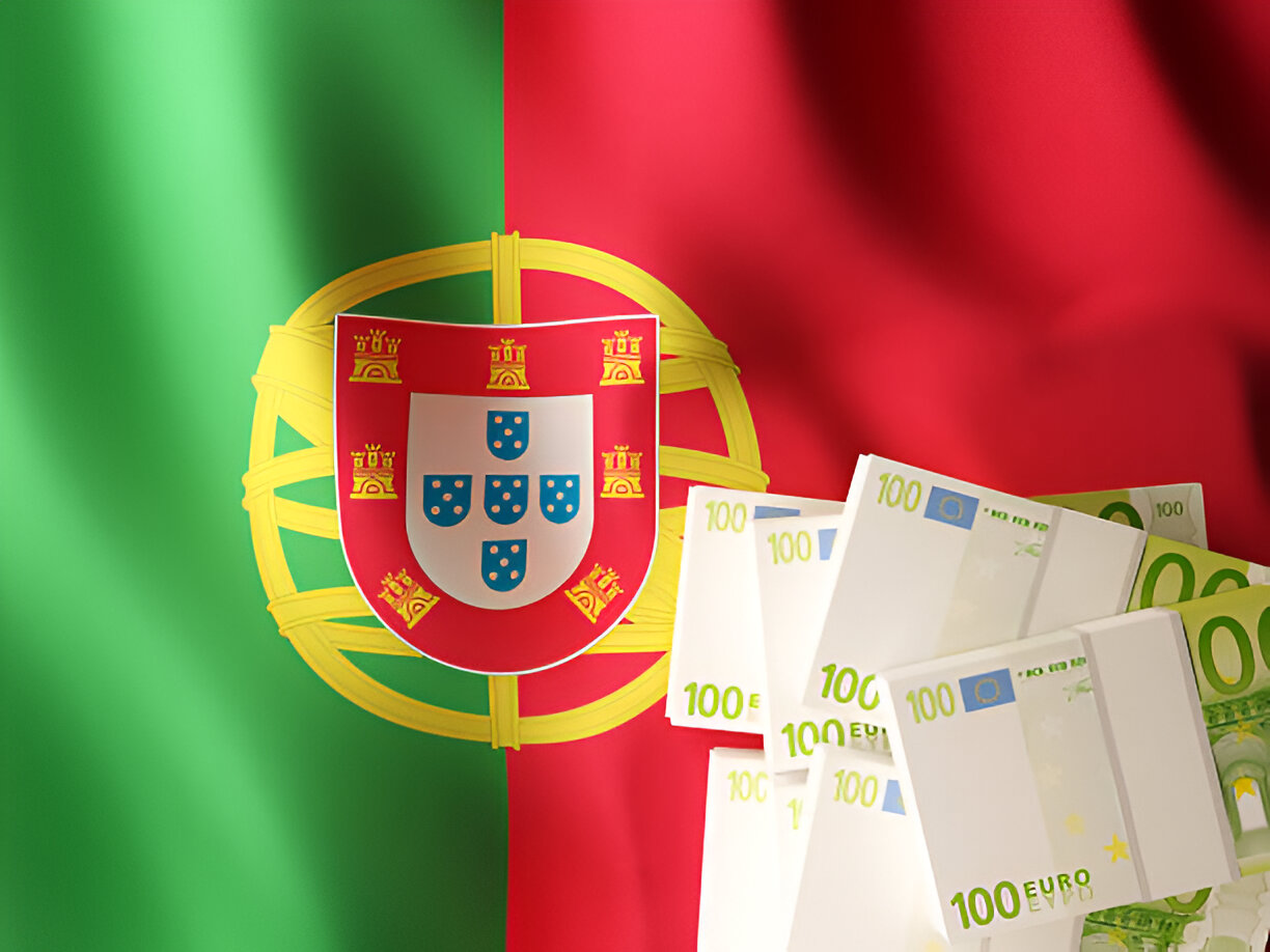 This image effectively conveys themes of wealth, investment, and national pride. Featuring the Portuguese flag prominently in the background alongside stacks of €100 euro bills, it symbolizes economic growth, financial opportunities, or programs like residency by investment in Portugal. It portrays Portugal as a destination for prosperity and monetary opportunities.